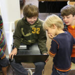 kids gathered around laptop
