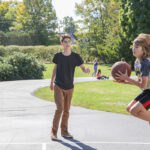 child jumping with basketball