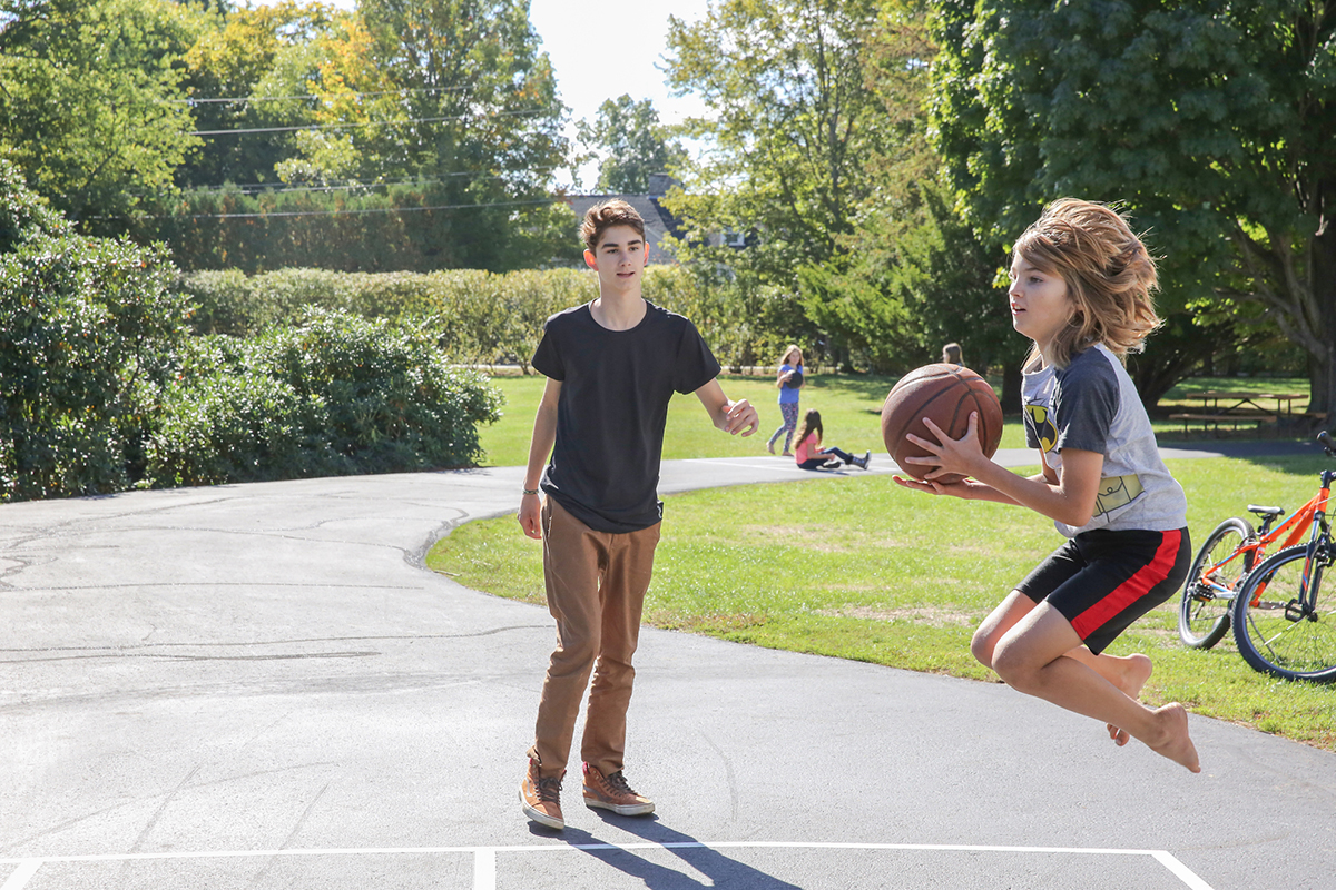 child jumping with basketball