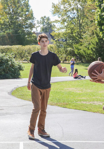 child jumping with basketball